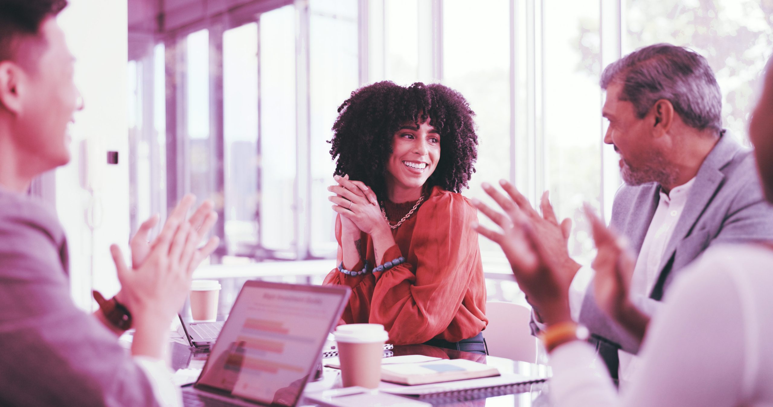 Hotwire leadership transitions press release header image of women in business meeting with colleagues